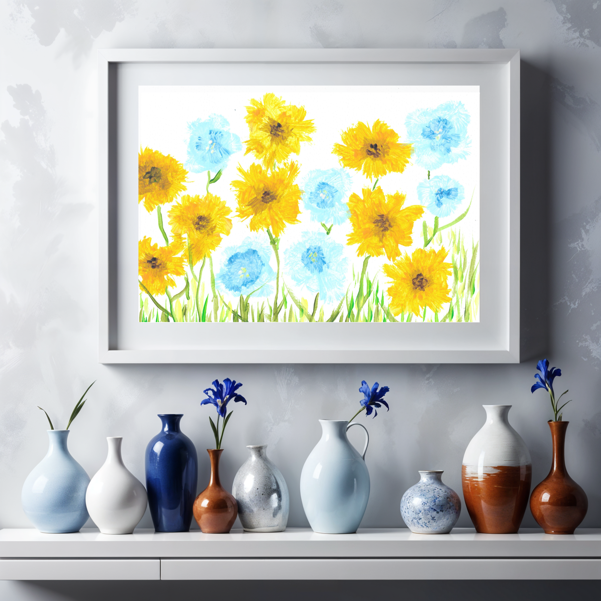 Framed floral artwork with yellow and blue flowers on a wall above a shelf with various vases.