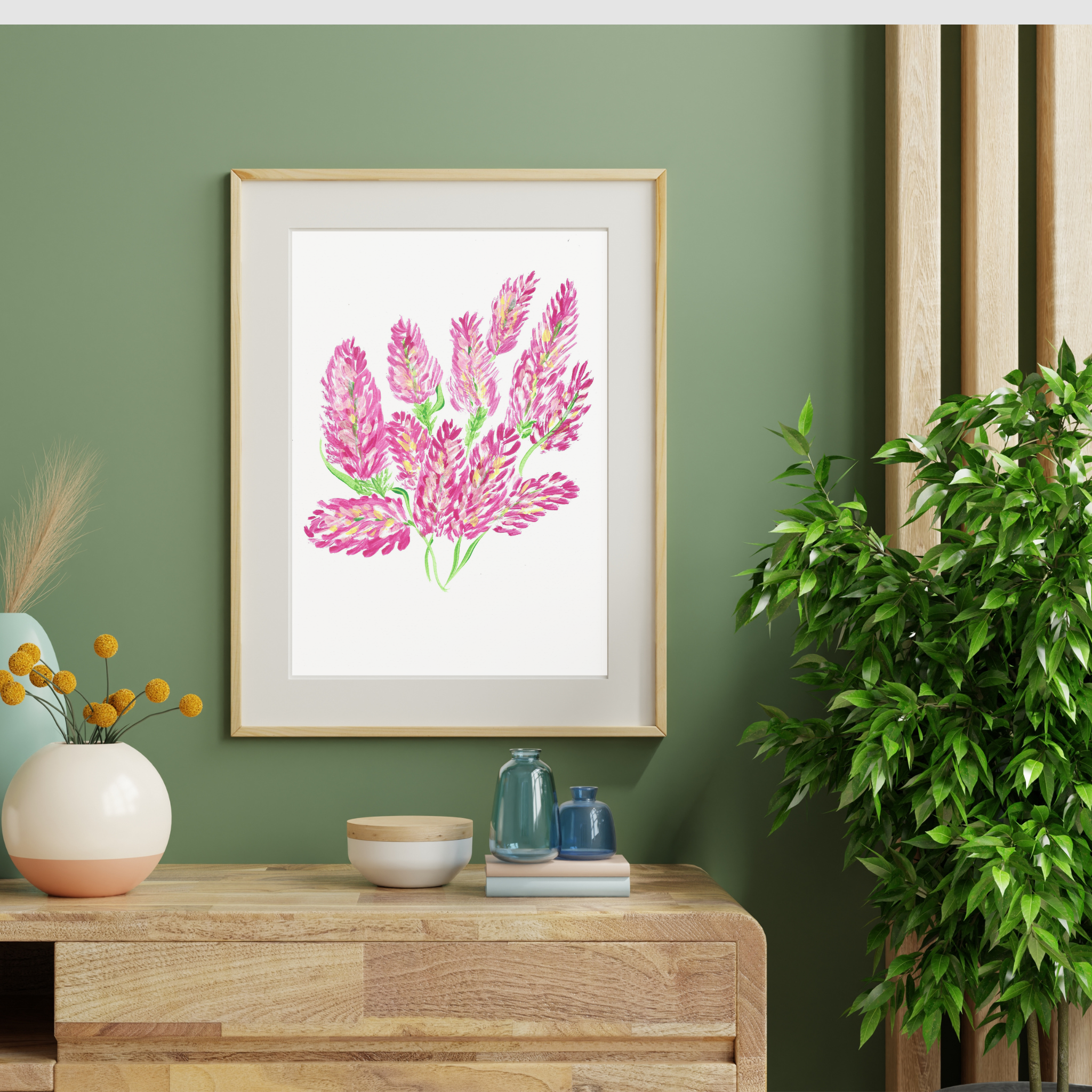 Framed floral artwork on a green wall with home decor items. Flowers in painting contrast with green wall. 